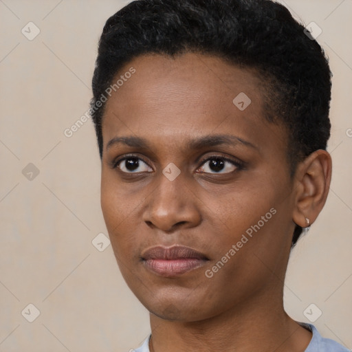 Joyful black young-adult female with short  black hair and brown eyes