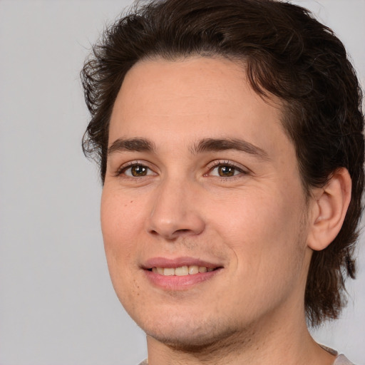 Joyful white young-adult male with medium  brown hair and brown eyes