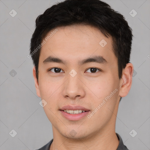 Joyful asian young-adult male with short  brown hair and brown eyes