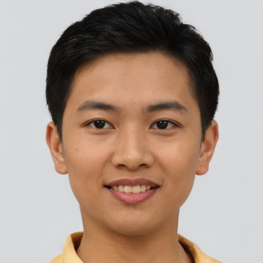 Joyful asian young-adult male with short  brown hair and brown eyes