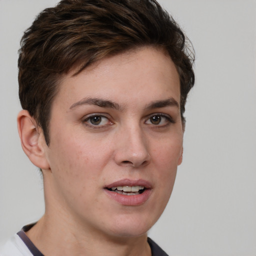 Joyful white young-adult female with short  brown hair and grey eyes