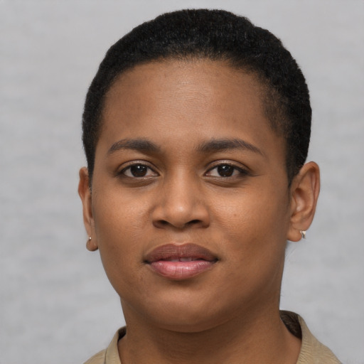 Joyful black young-adult female with short  brown hair and brown eyes