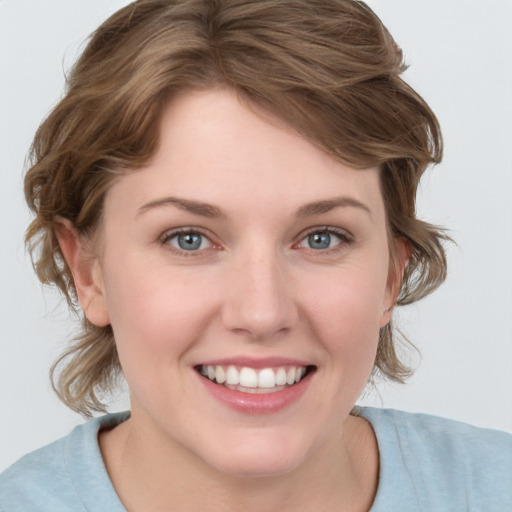 Joyful white young-adult female with medium  brown hair and blue eyes