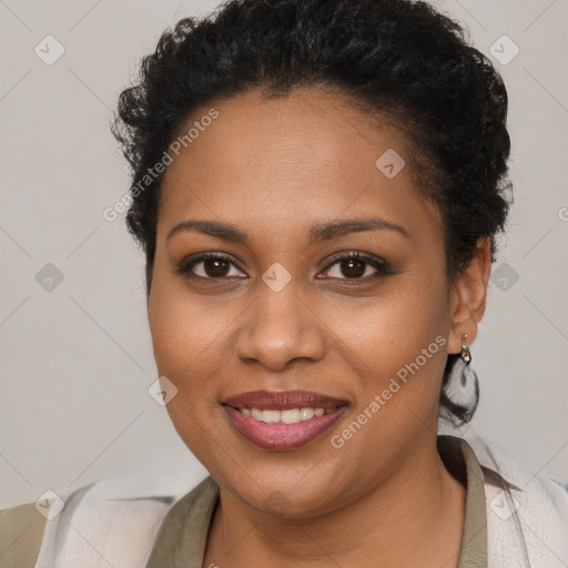 Joyful black young-adult female with short  brown hair and brown eyes