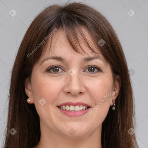 Joyful white adult female with long  brown hair and grey eyes