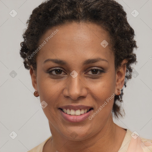 Joyful black adult female with short  brown hair and brown eyes