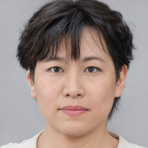 Neutral asian adult female with short  brown hair and brown eyes