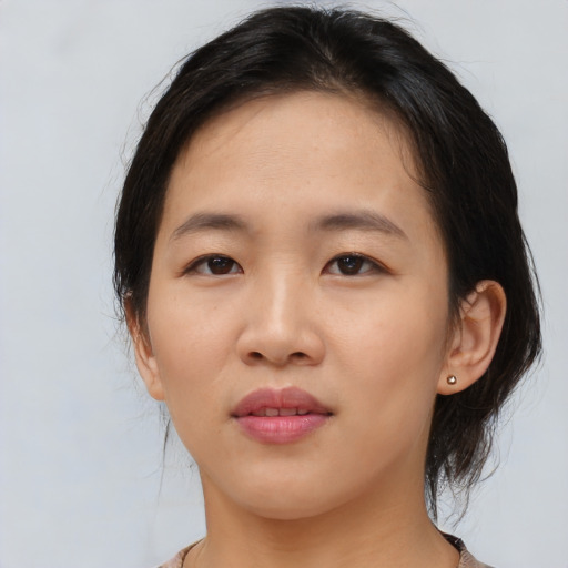 Joyful asian young-adult female with medium  brown hair and brown eyes