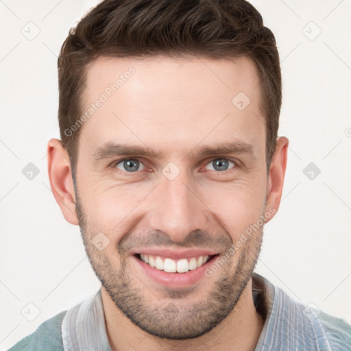 Joyful white young-adult male with short  brown hair and grey eyes