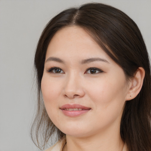 Joyful asian young-adult female with long  brown hair and brown eyes