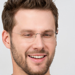 Joyful white adult male with short  brown hair and grey eyes