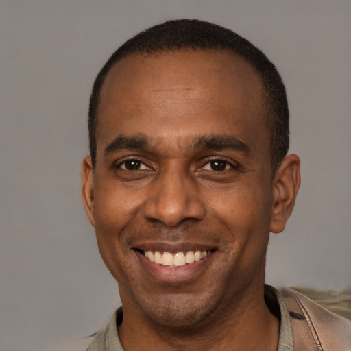 Joyful latino adult male with short  brown hair and brown eyes