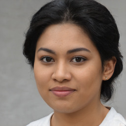 Joyful latino young-adult female with medium  black hair and brown eyes