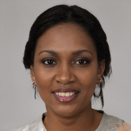 Joyful black young-adult female with medium  black hair and brown eyes