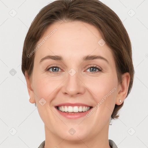 Joyful white young-adult female with short  brown hair and grey eyes