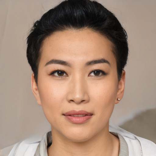 Joyful asian young-adult female with short  brown hair and brown eyes