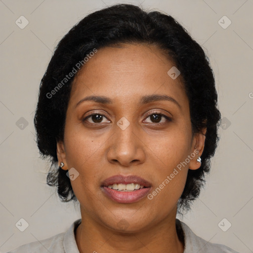 Joyful black adult female with medium  brown hair and brown eyes