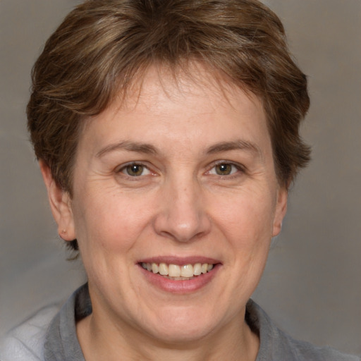 Joyful white adult female with medium  brown hair and grey eyes