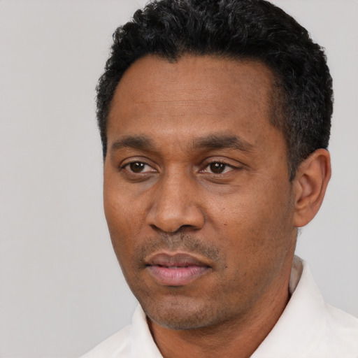 Neutral black adult male with short  black hair and brown eyes