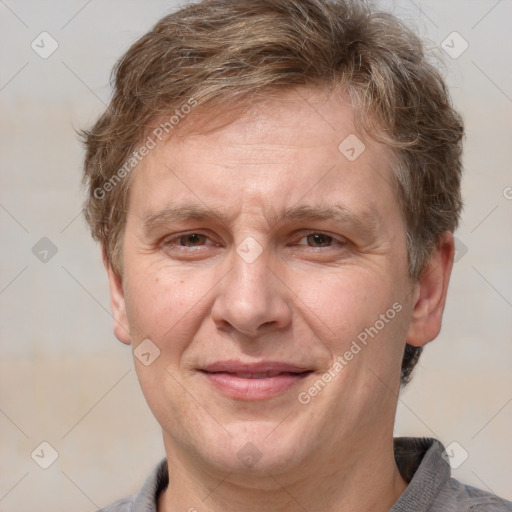 Joyful white adult male with short  brown hair and grey eyes