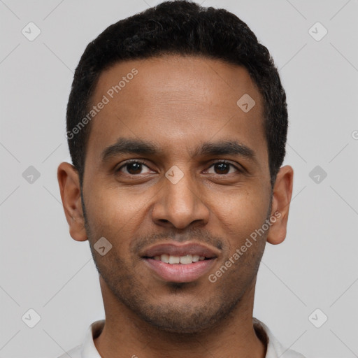 Joyful black young-adult male with short  black hair and brown eyes