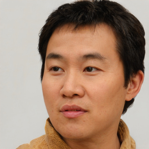 Neutral asian young-adult male with short  brown hair and brown eyes