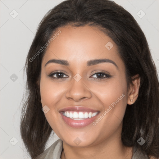 Joyful latino young-adult female with long  brown hair and brown eyes