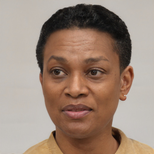 Joyful black adult female with short  black hair and brown eyes