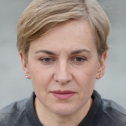 Joyful white adult female with short  brown hair and blue eyes