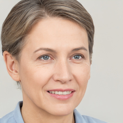 Joyful white adult female with short  brown hair and brown eyes