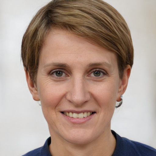 Joyful white adult female with short  brown hair and grey eyes