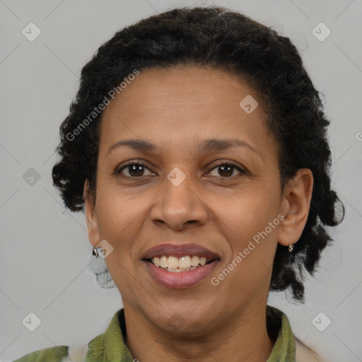 Joyful black adult female with medium  brown hair and brown eyes