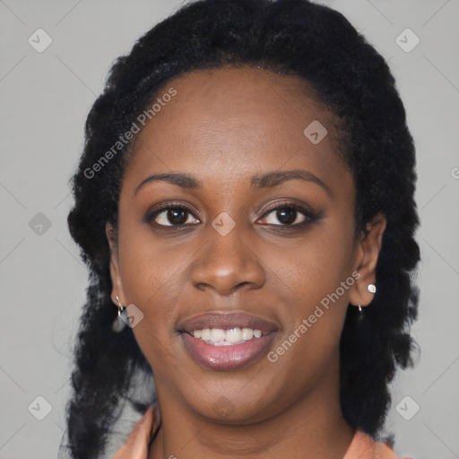 Joyful black young-adult female with long  black hair and brown eyes