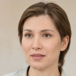 Joyful white adult female with medium  brown hair and grey eyes