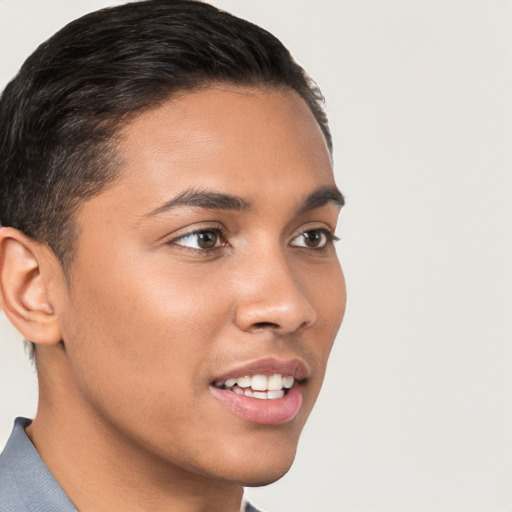 Joyful latino young-adult male with short  brown hair and brown eyes