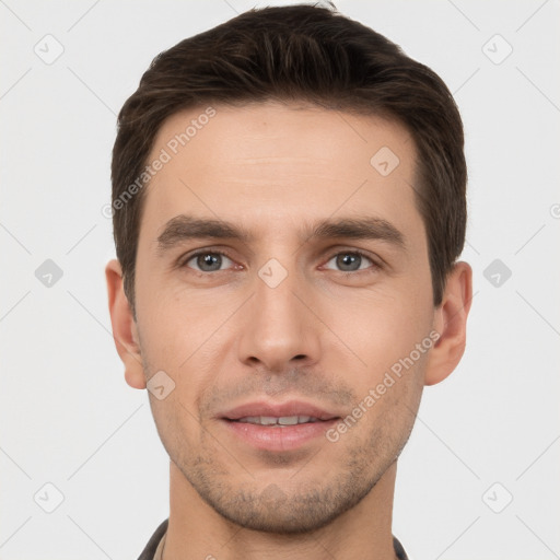 Joyful white young-adult male with short  brown hair and brown eyes