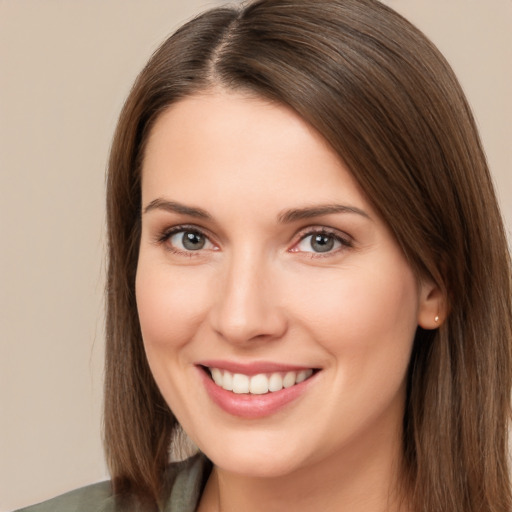 Joyful white young-adult female with long  brown hair and brown eyes