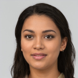 Joyful latino young-adult female with long  brown hair and brown eyes