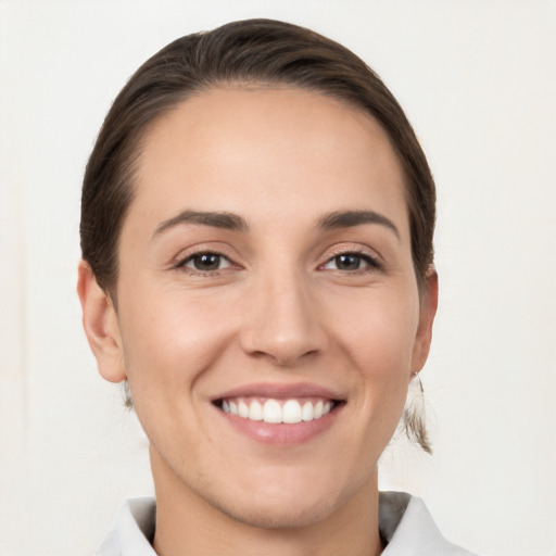 Joyful white young-adult female with short  brown hair and brown eyes