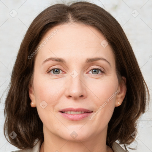 Joyful white adult female with medium  brown hair and green eyes