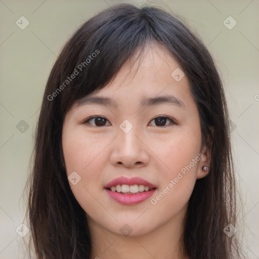 Joyful asian young-adult female with long  brown hair and brown eyes