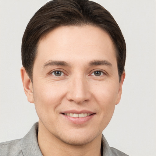 Joyful white young-adult male with short  brown hair and brown eyes