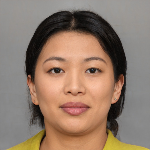 Joyful asian young-adult female with medium  black hair and brown eyes