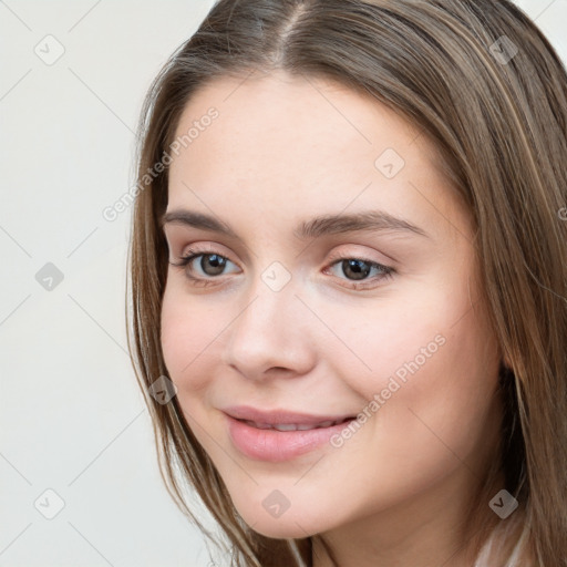 Joyful white young-adult female with long  brown hair and grey eyes