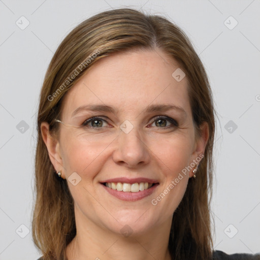 Joyful white adult female with medium  brown hair and grey eyes