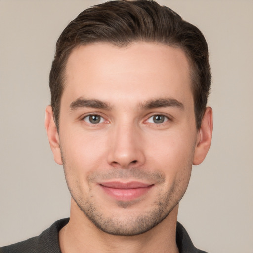 Joyful white young-adult male with short  brown hair and brown eyes