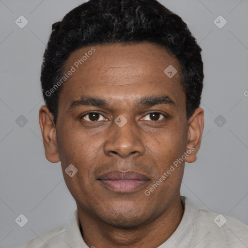 Joyful black young-adult male with short  black hair and brown eyes
