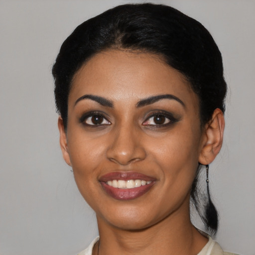 Joyful black young-adult female with medium  black hair and brown eyes