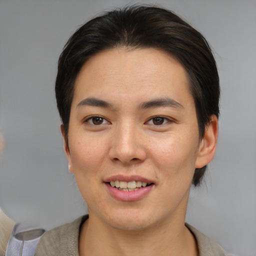 Joyful asian young-adult female with short  brown hair and brown eyes