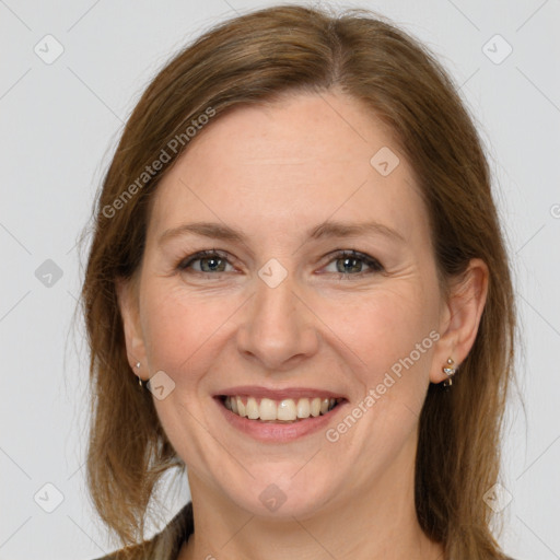 Joyful white adult female with long  brown hair and grey eyes